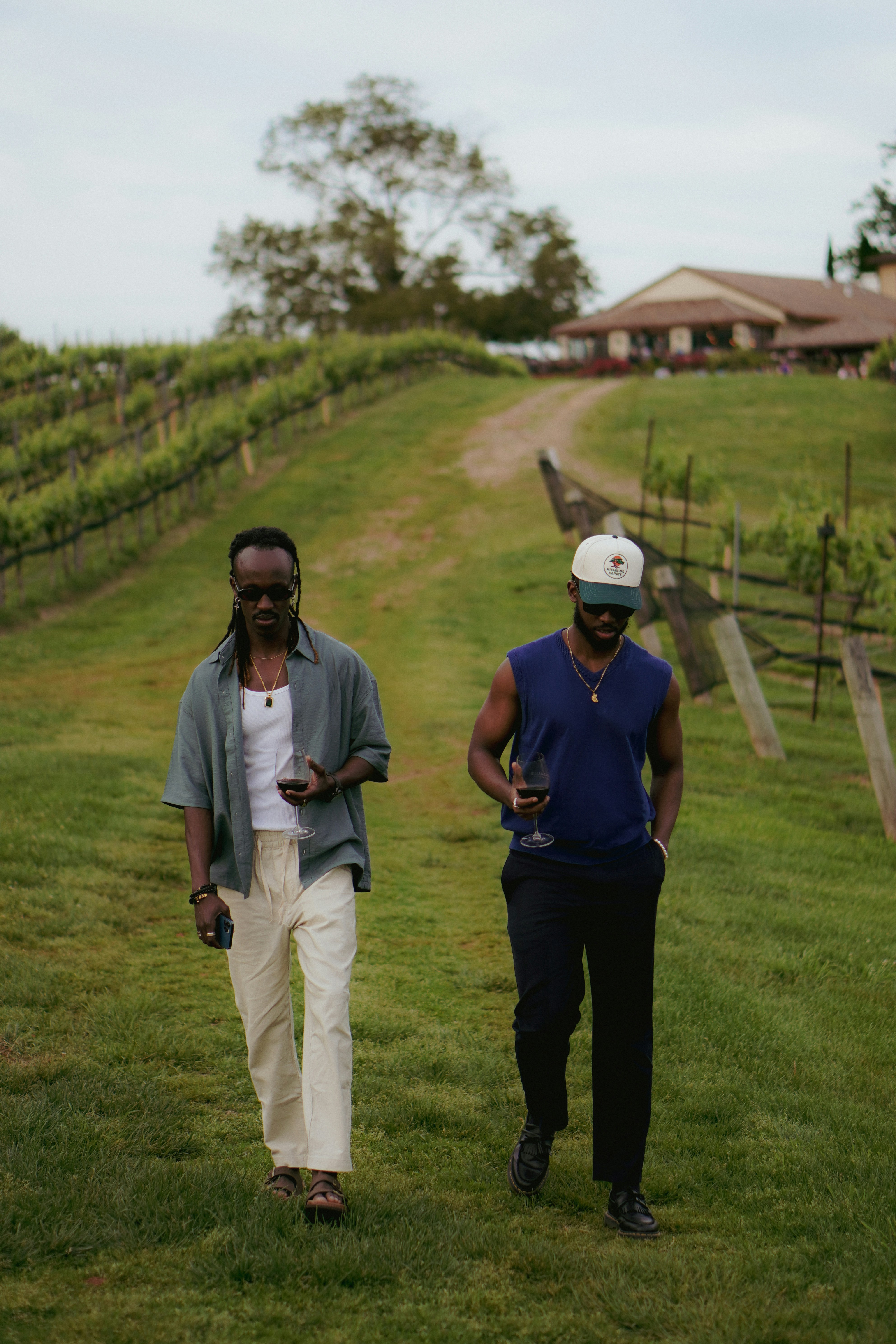 A couple of men standing on top of a lush green field