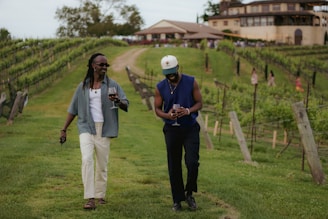 A couple of men walking across a lush green field