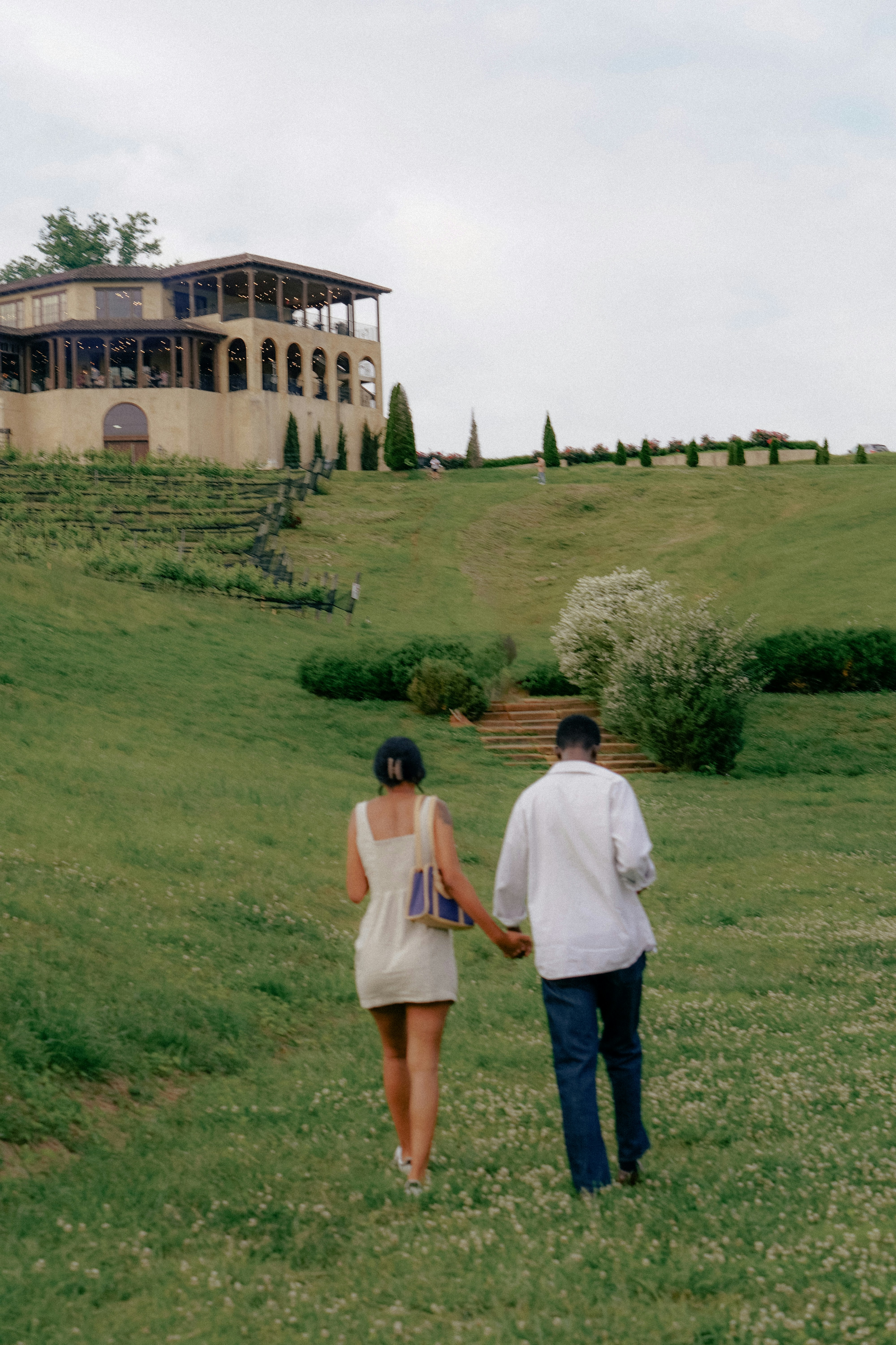 A man and a woman walking in a field