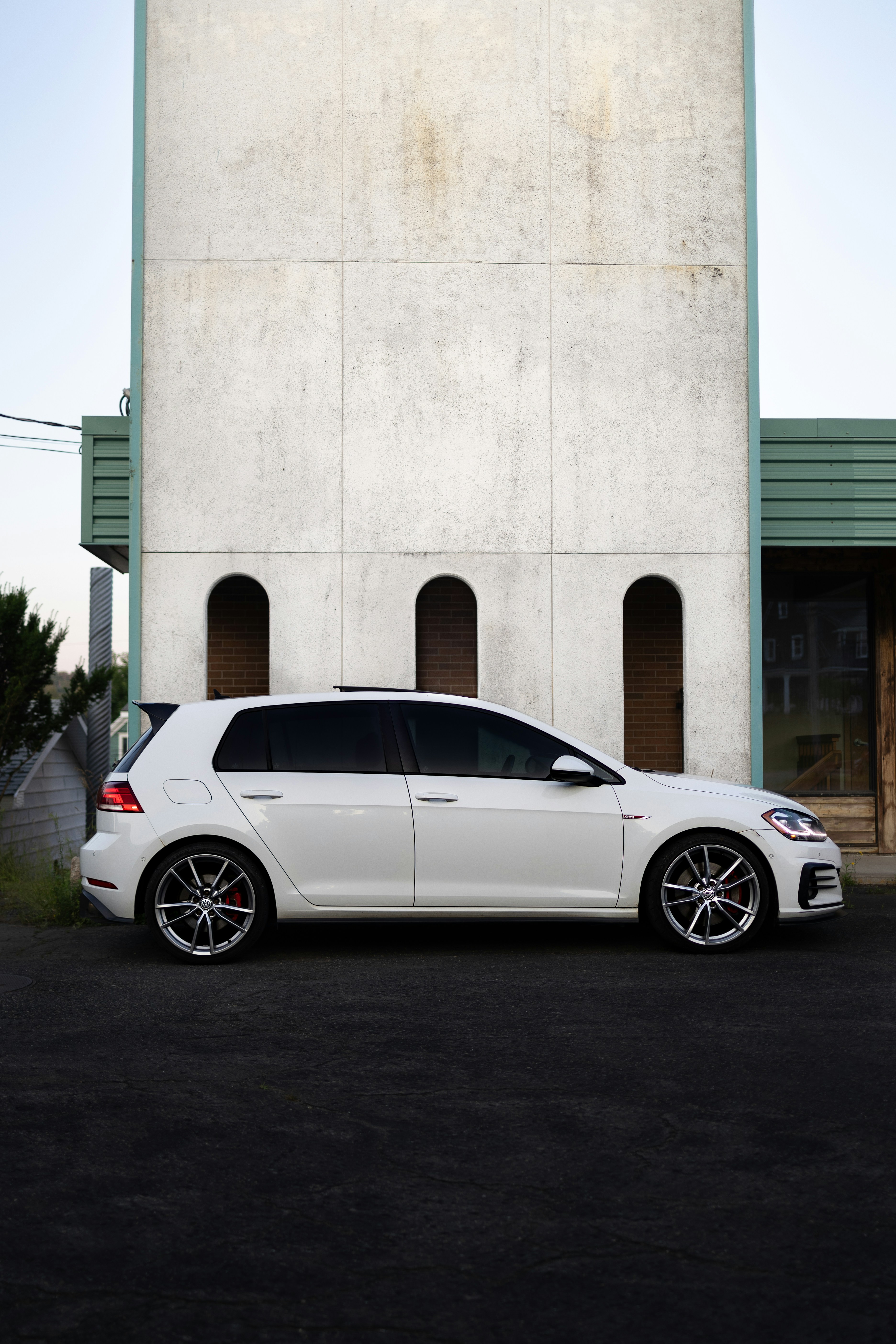 A white car parked in front of a building