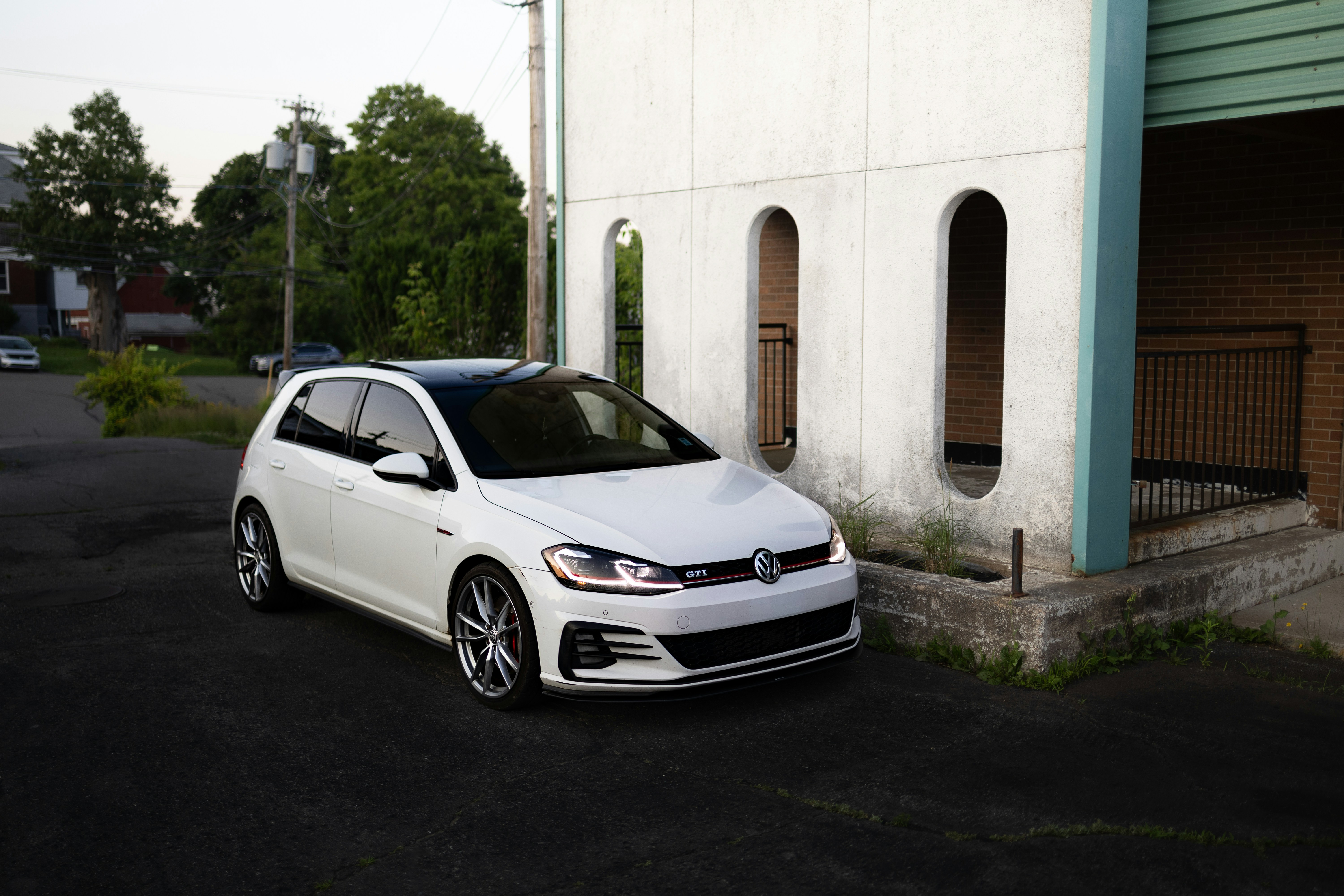 A white car parked in front of a building