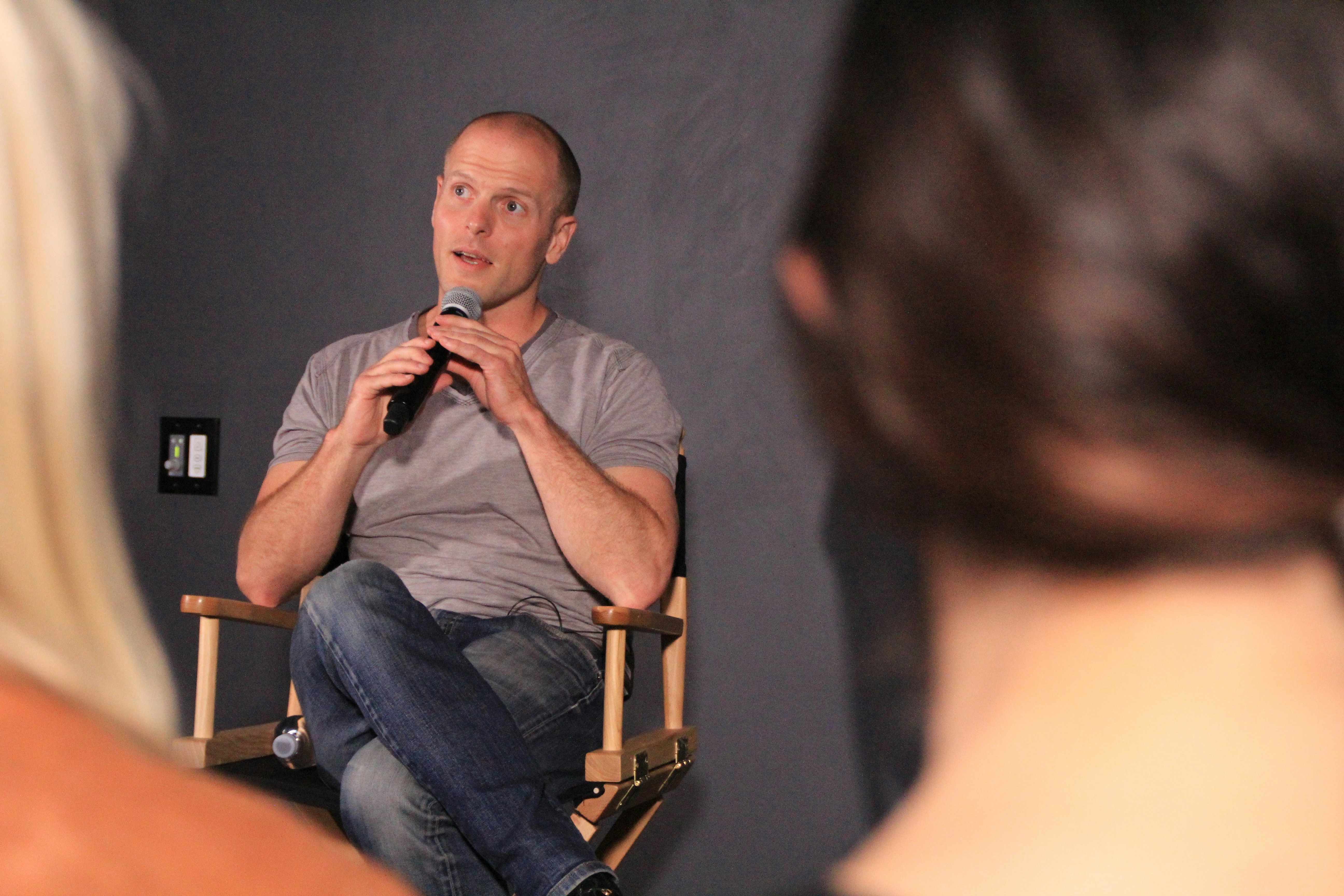A man sitting in a chair in front of a mirror