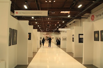 A group of people walking down a long hallway