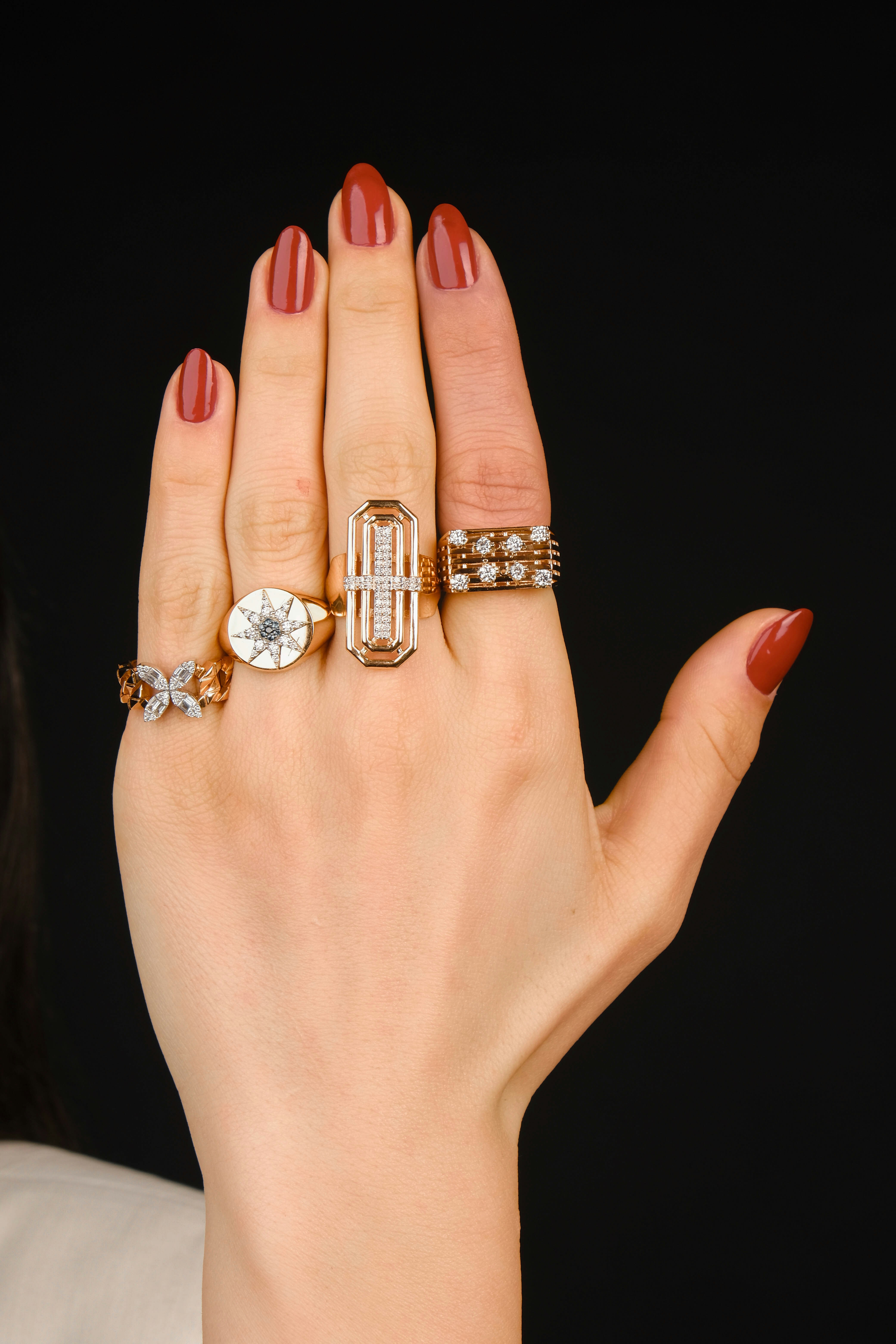 A woman's hand with three rings on it