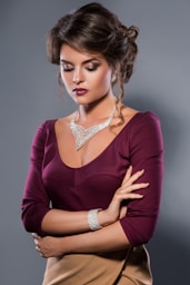 A woman in a dress with her arms crossed