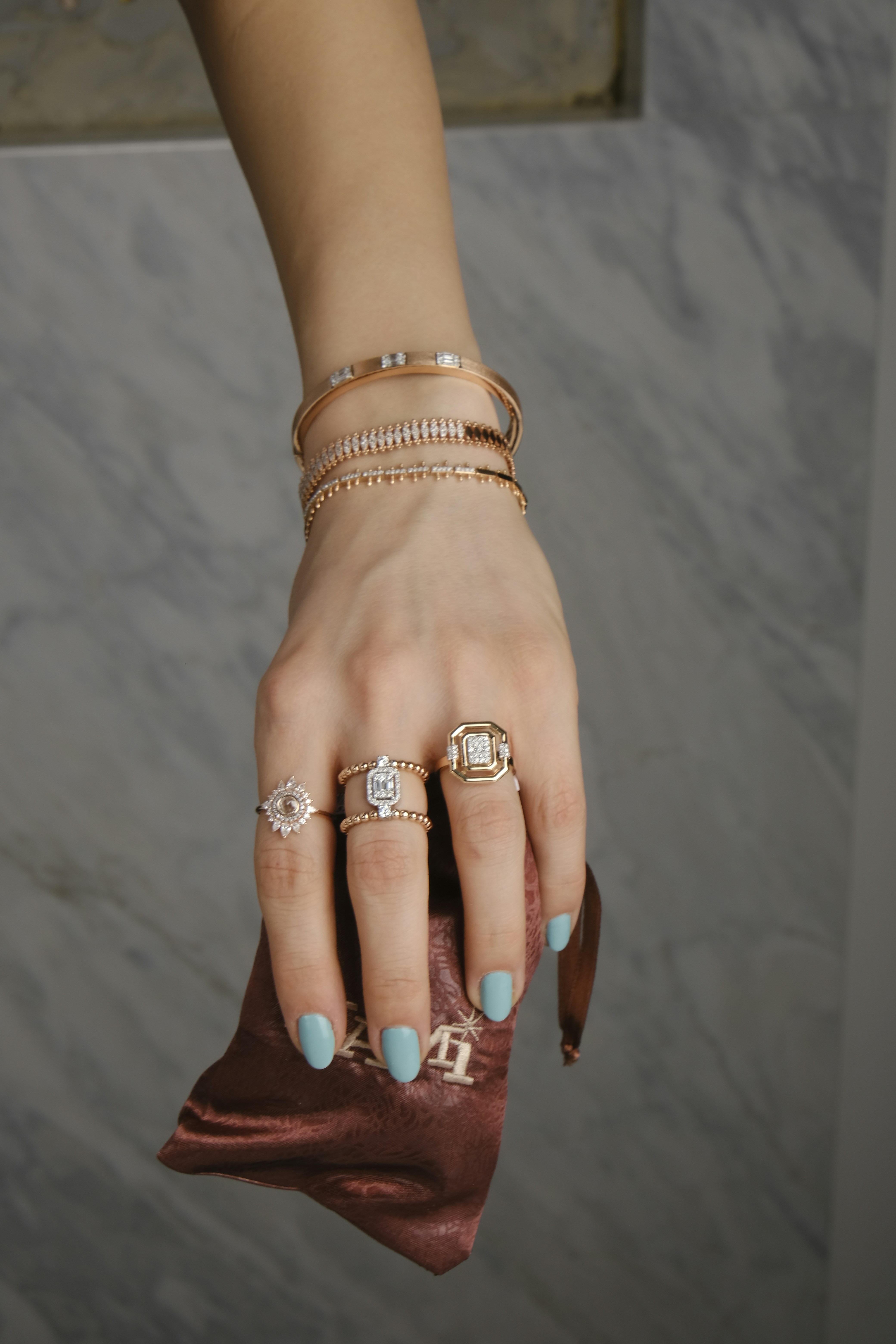 A woman's hand with rings and a purse