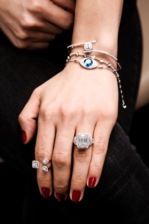 A woman's hand wearing a ring and bracelet