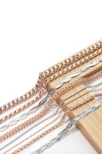 A bunch of different types of chains on a white background