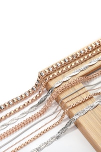A bunch of different types of chains on a white background