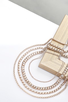 A wooden box with a chain attached to it
