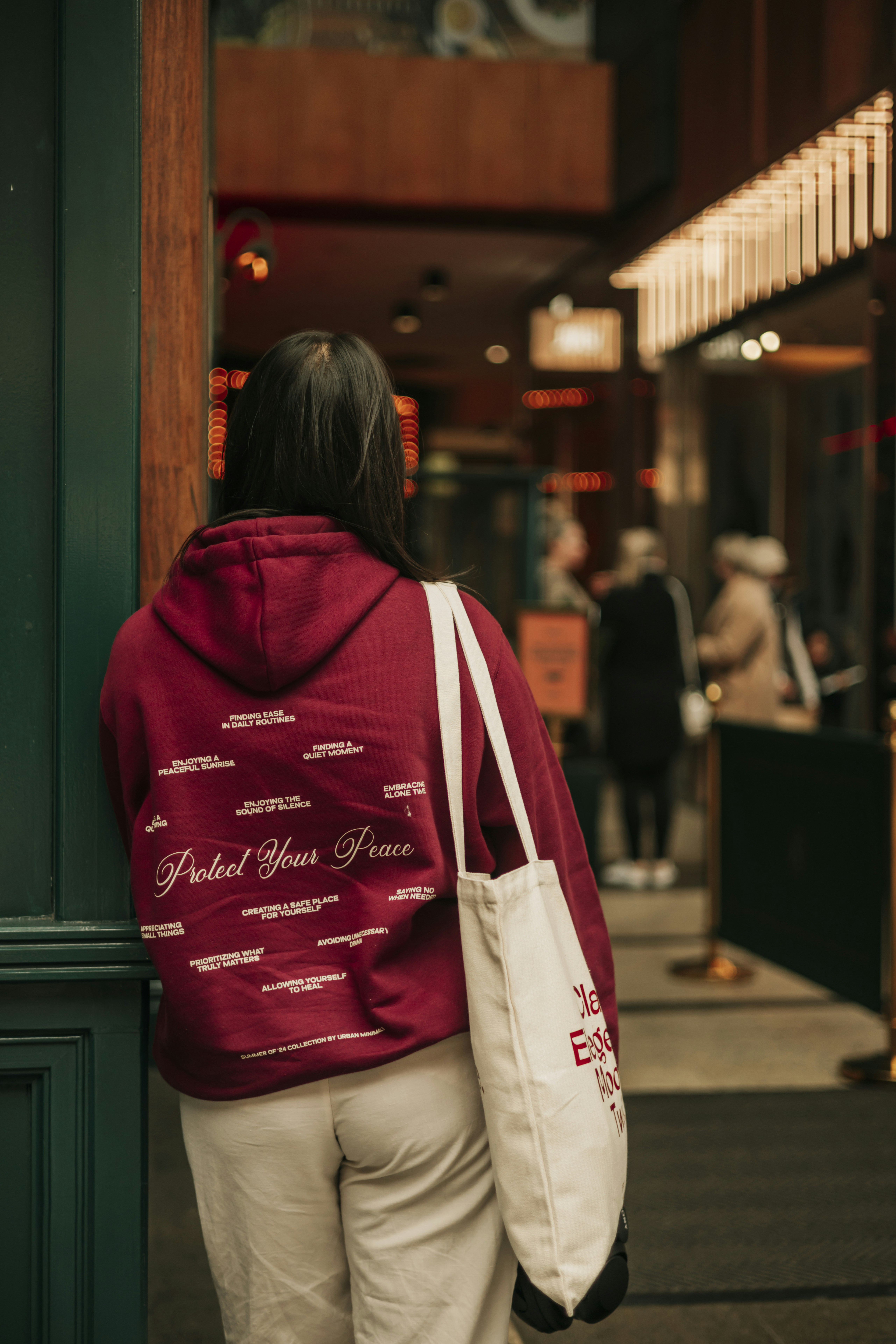 A woman in a red jacket is walking down the street