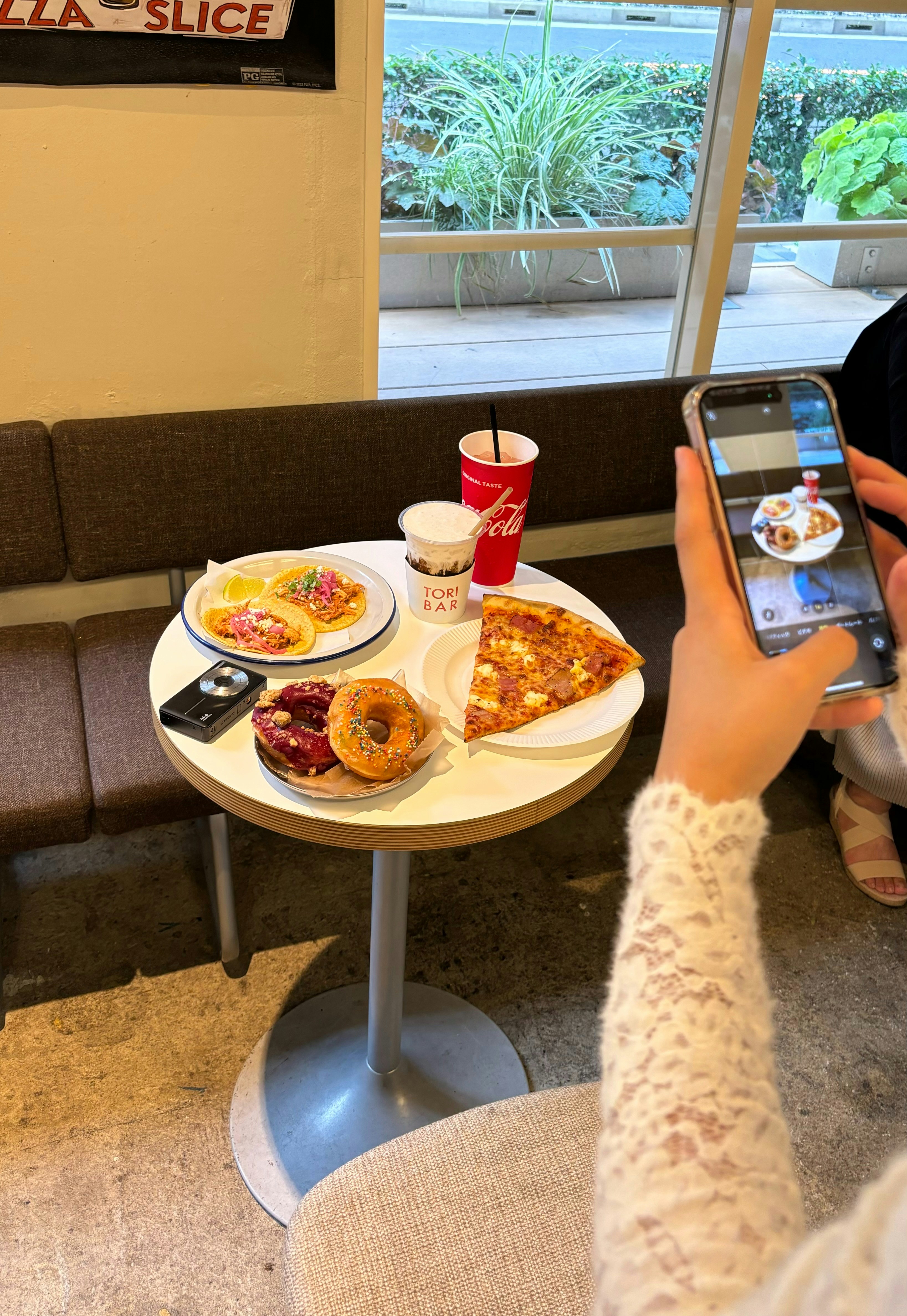 A woman taking a picture of food on her phone