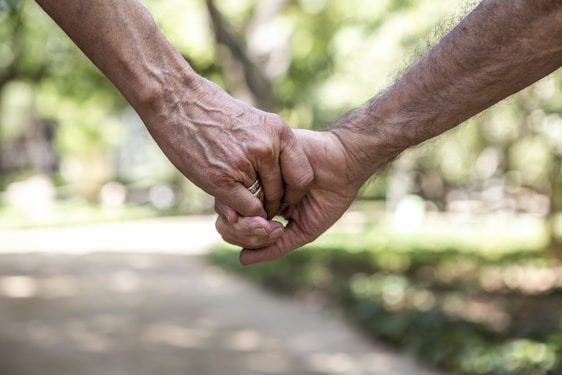 A close up of two people holding hands