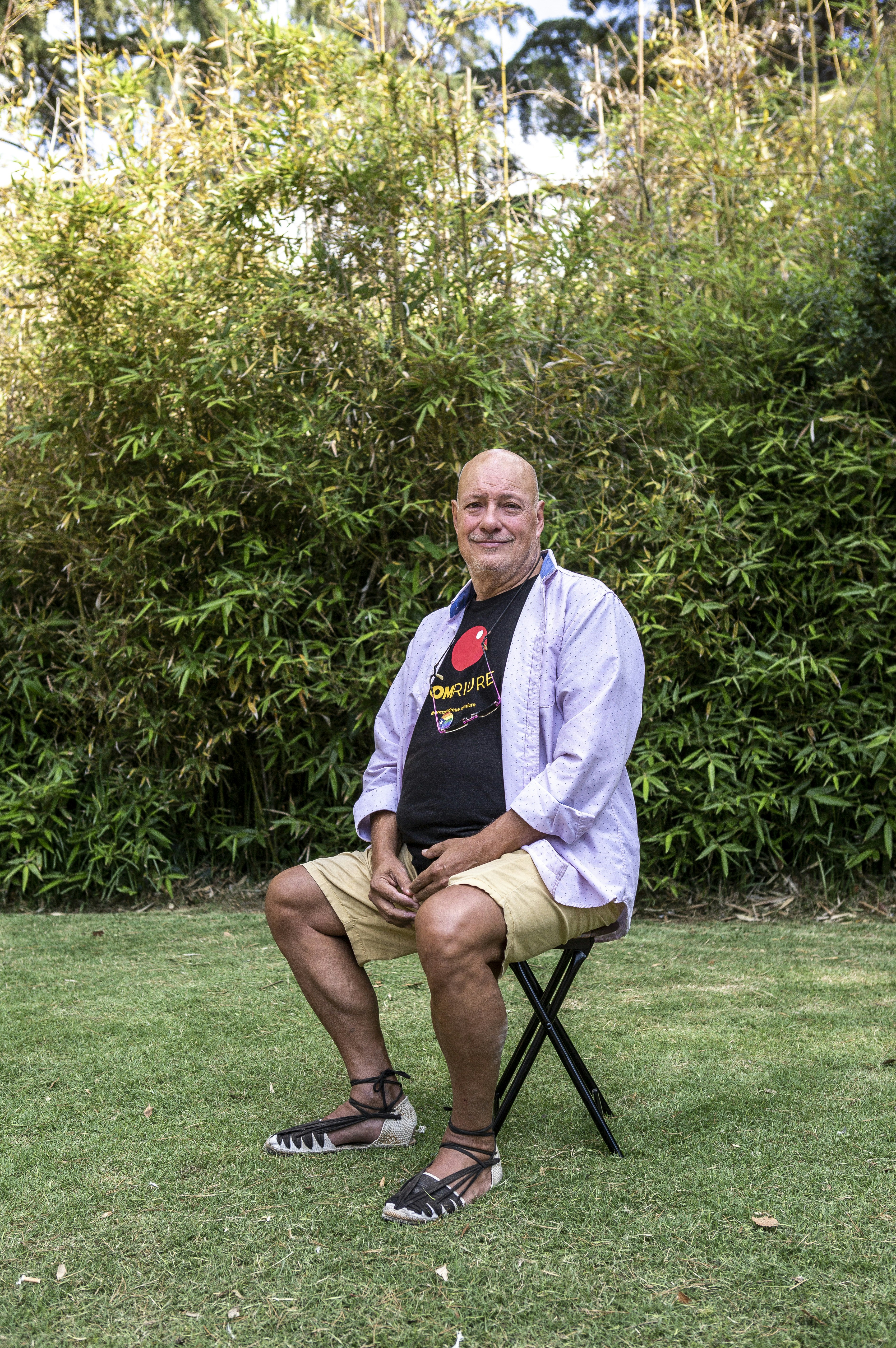 A man sitting on a chair in a yard