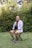 A man sitting on a chair in a yard