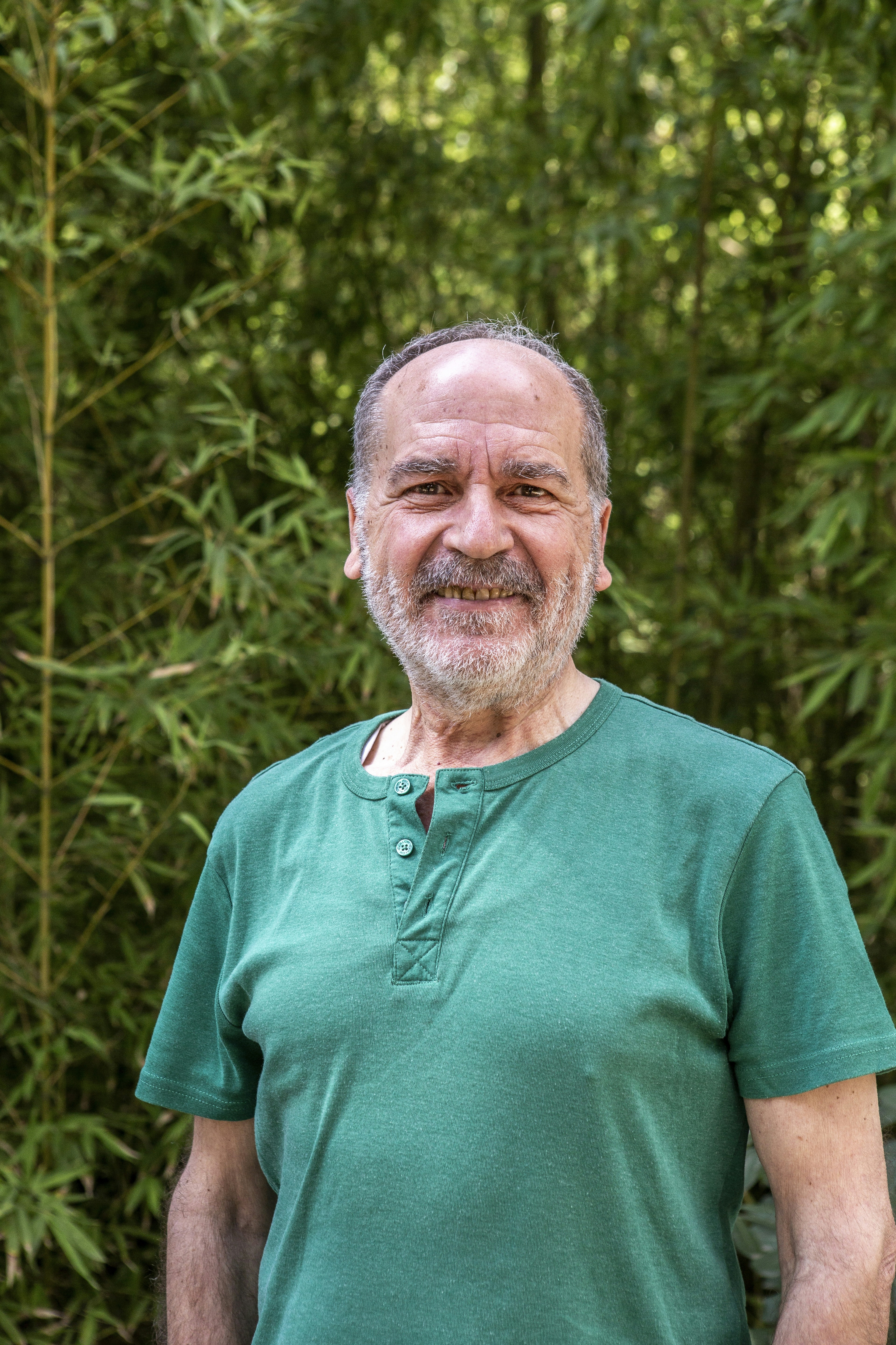A man standing in front of a bamboo tree