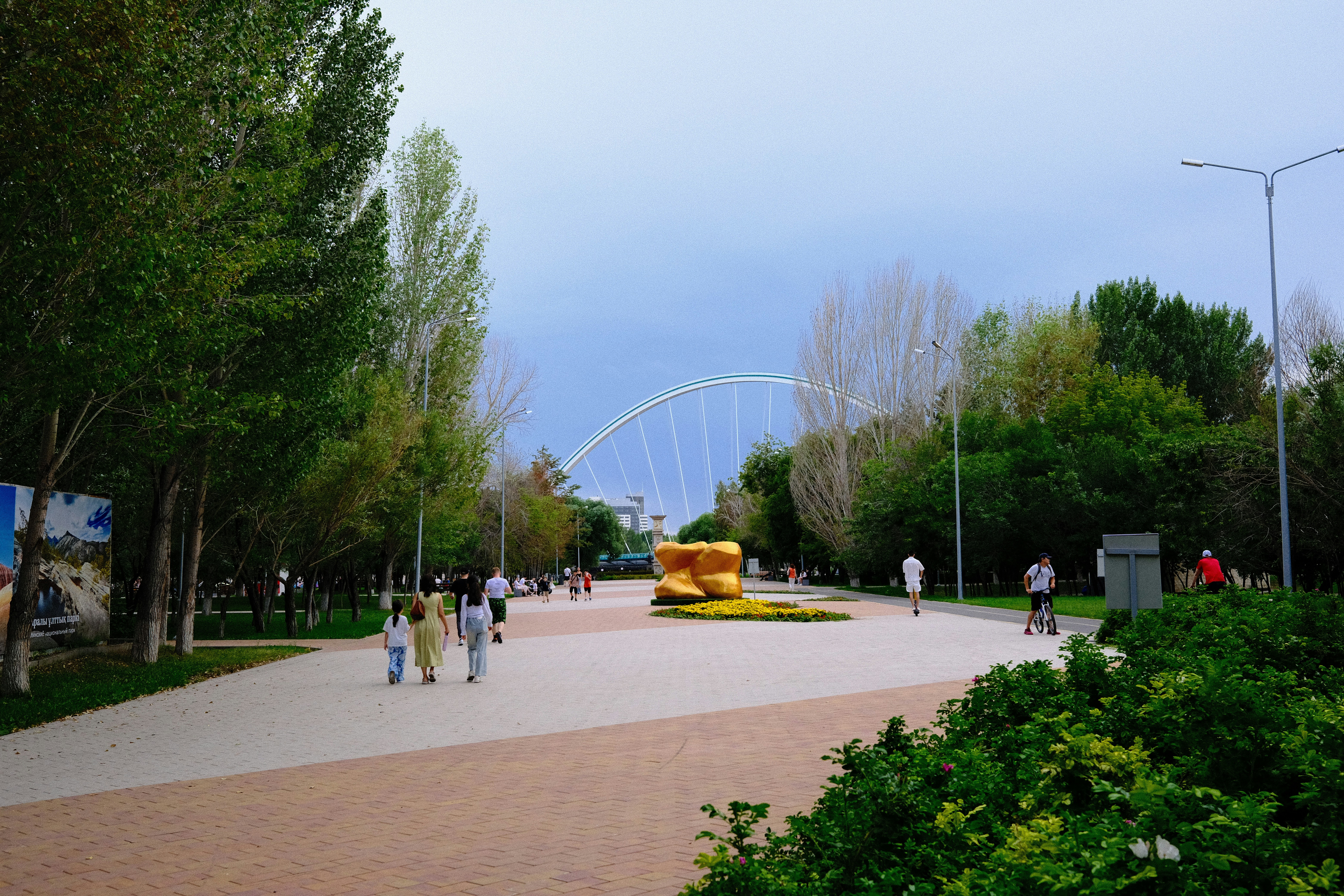 A group of people walking around a park