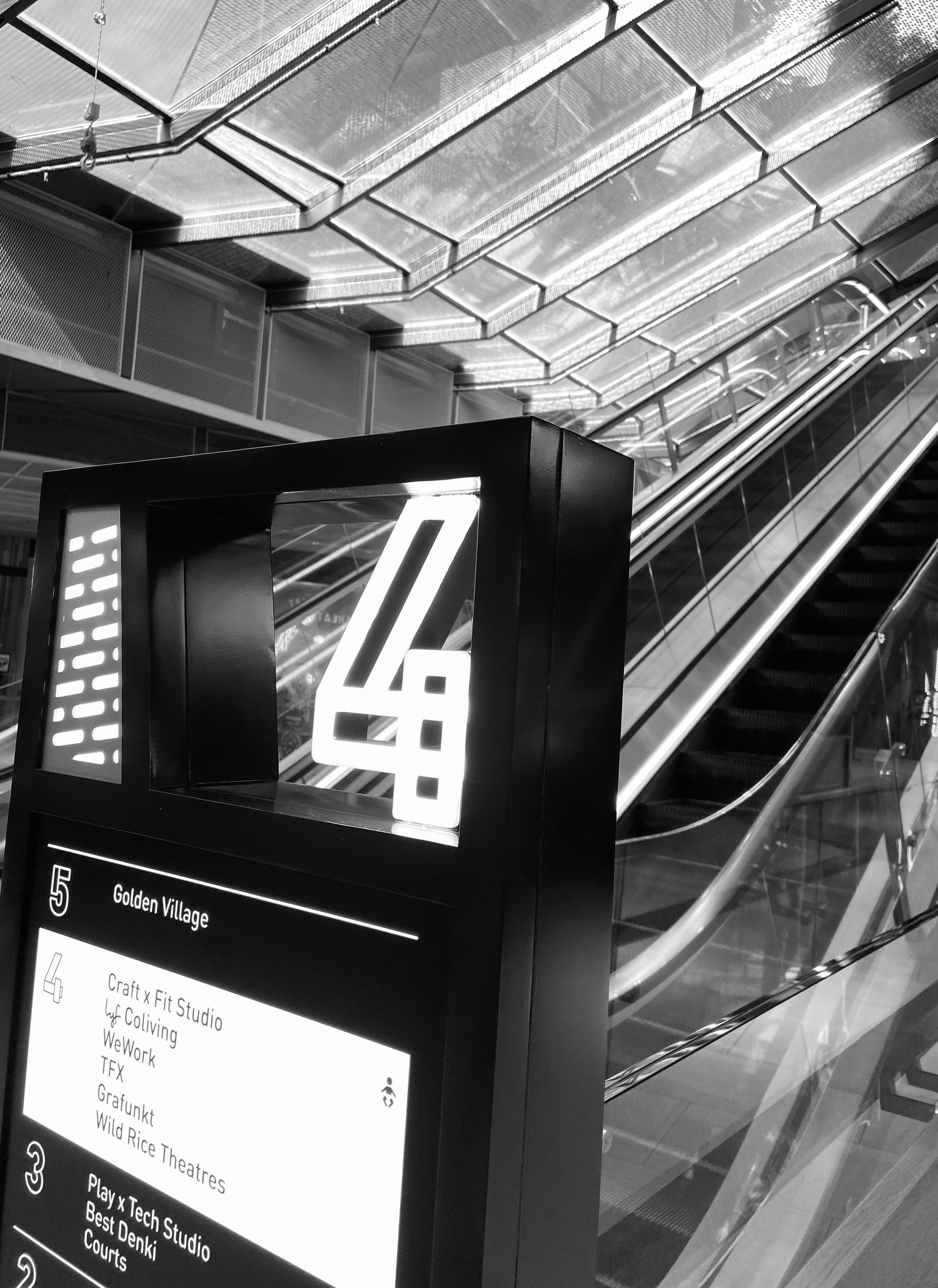 A black and white photo of an escalator