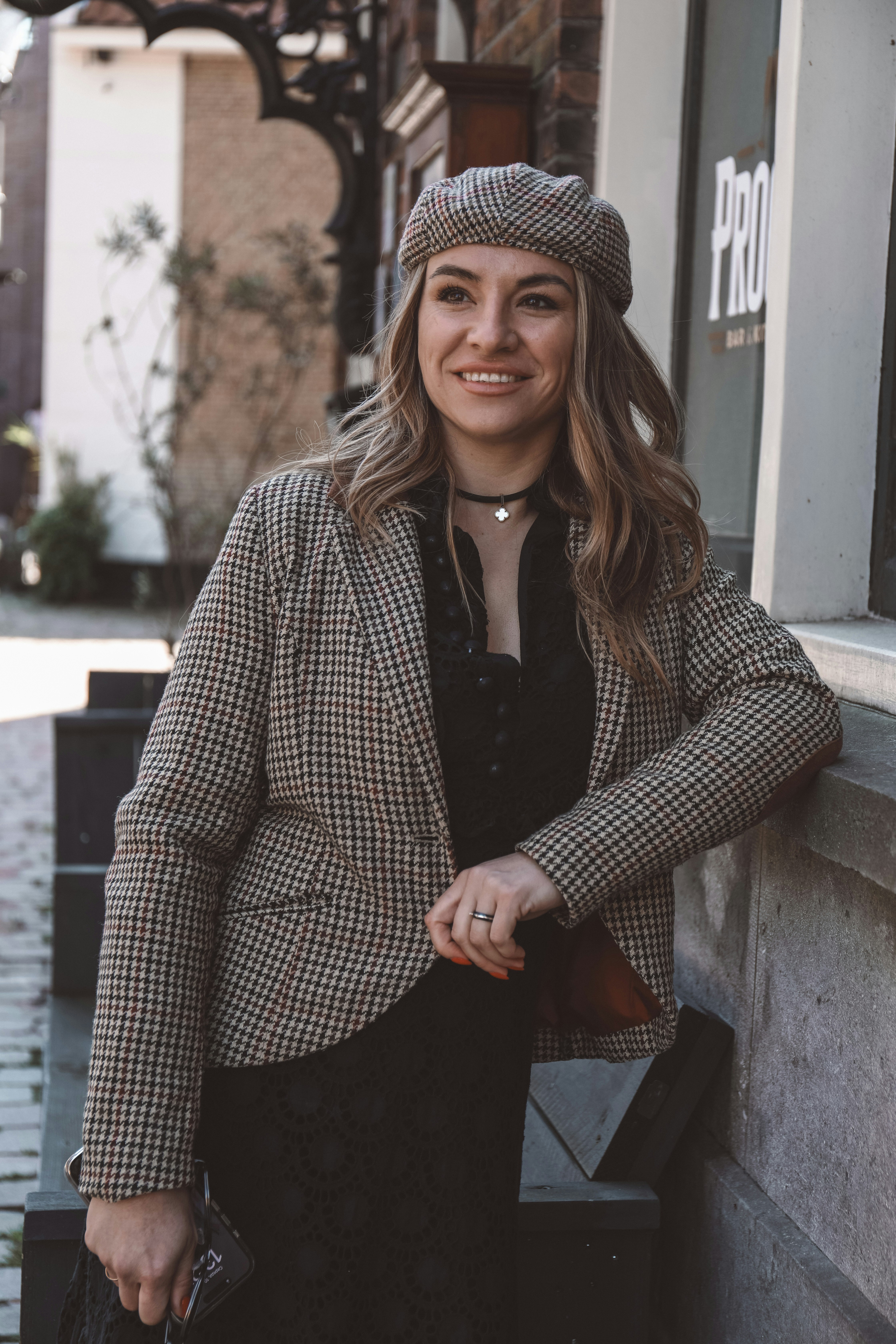 A woman standing on the side of a building