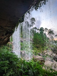 A view of a waterfall from inside a cave