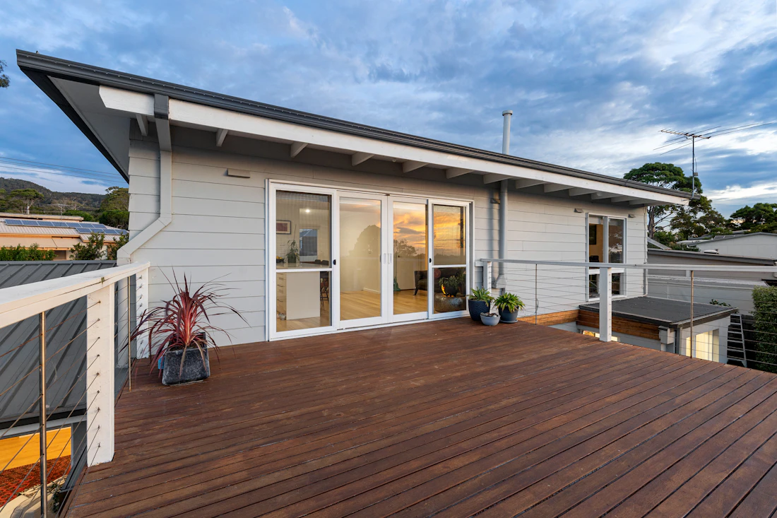 Residential wood deck with cable railing around the outdoor living area