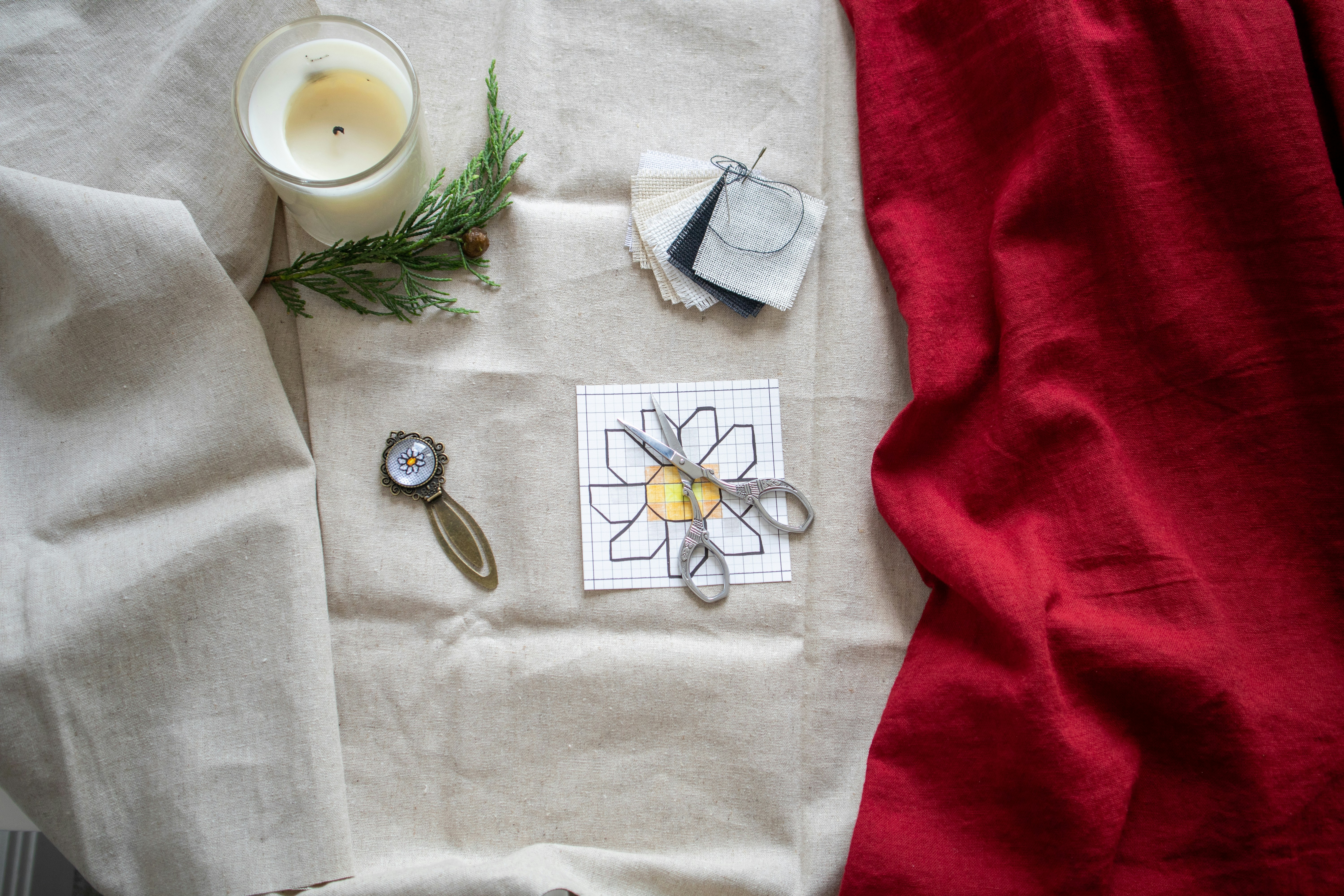 A table topped with a white table cloth and a candle
