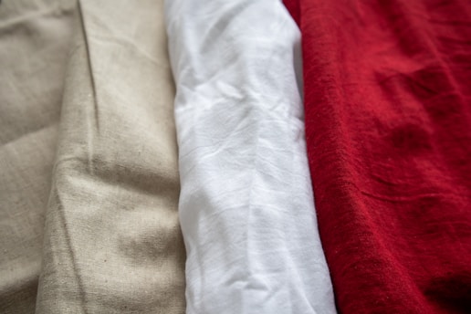 A close up of three different colored shirts