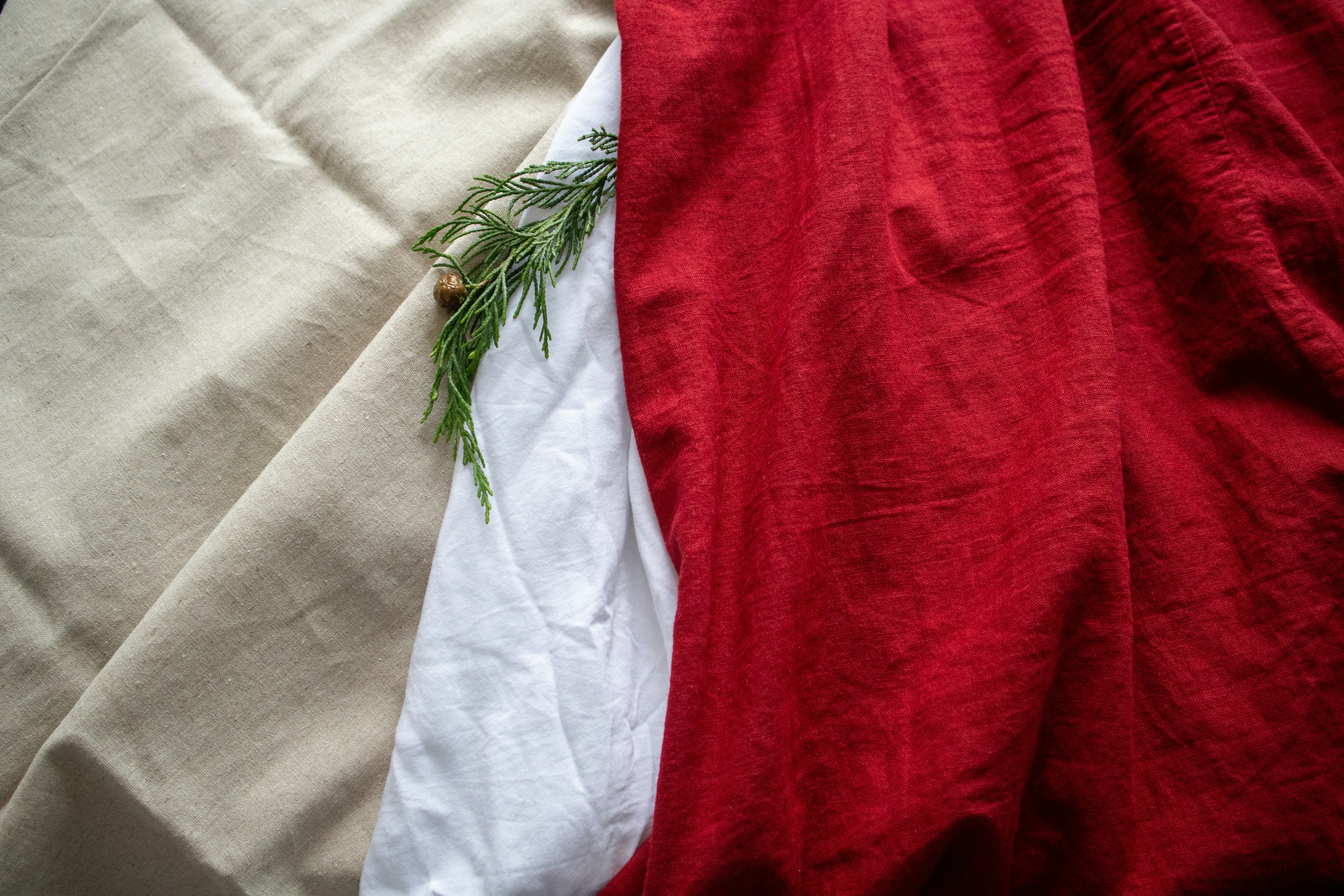 A red, white and green blanket laying on top of each other