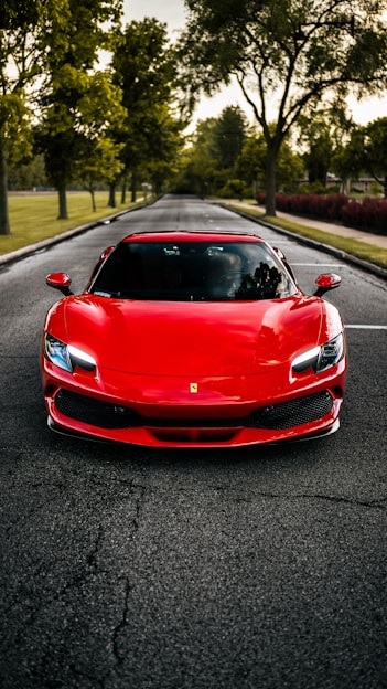 A red sports car parked on the side of a road