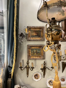 A room with a lamp and pictures on the wall