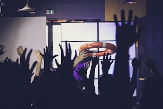 A group of people raising their hands in the air