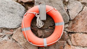 A life preserver hanging on a rock wall