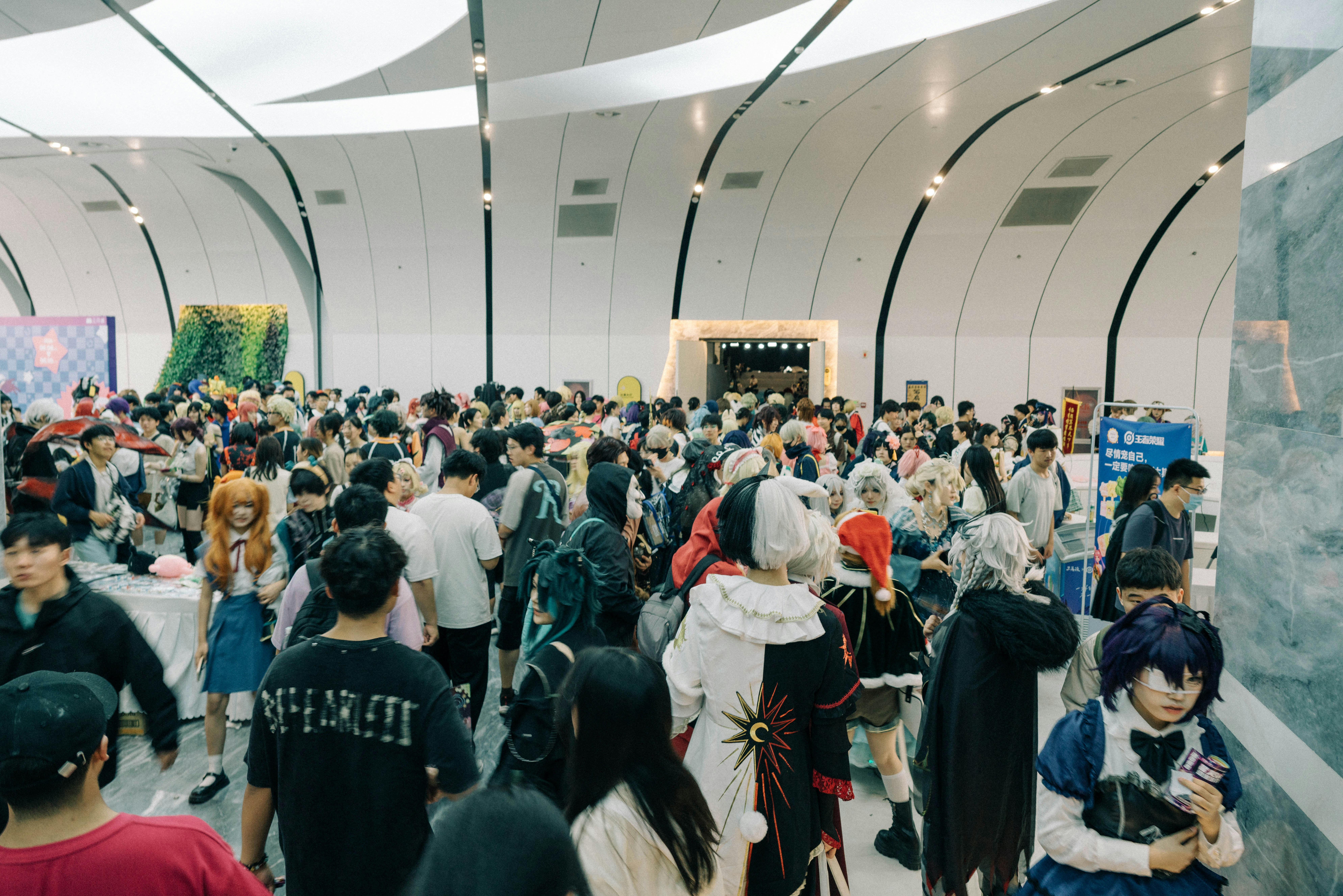 A large group of people standing in a building
