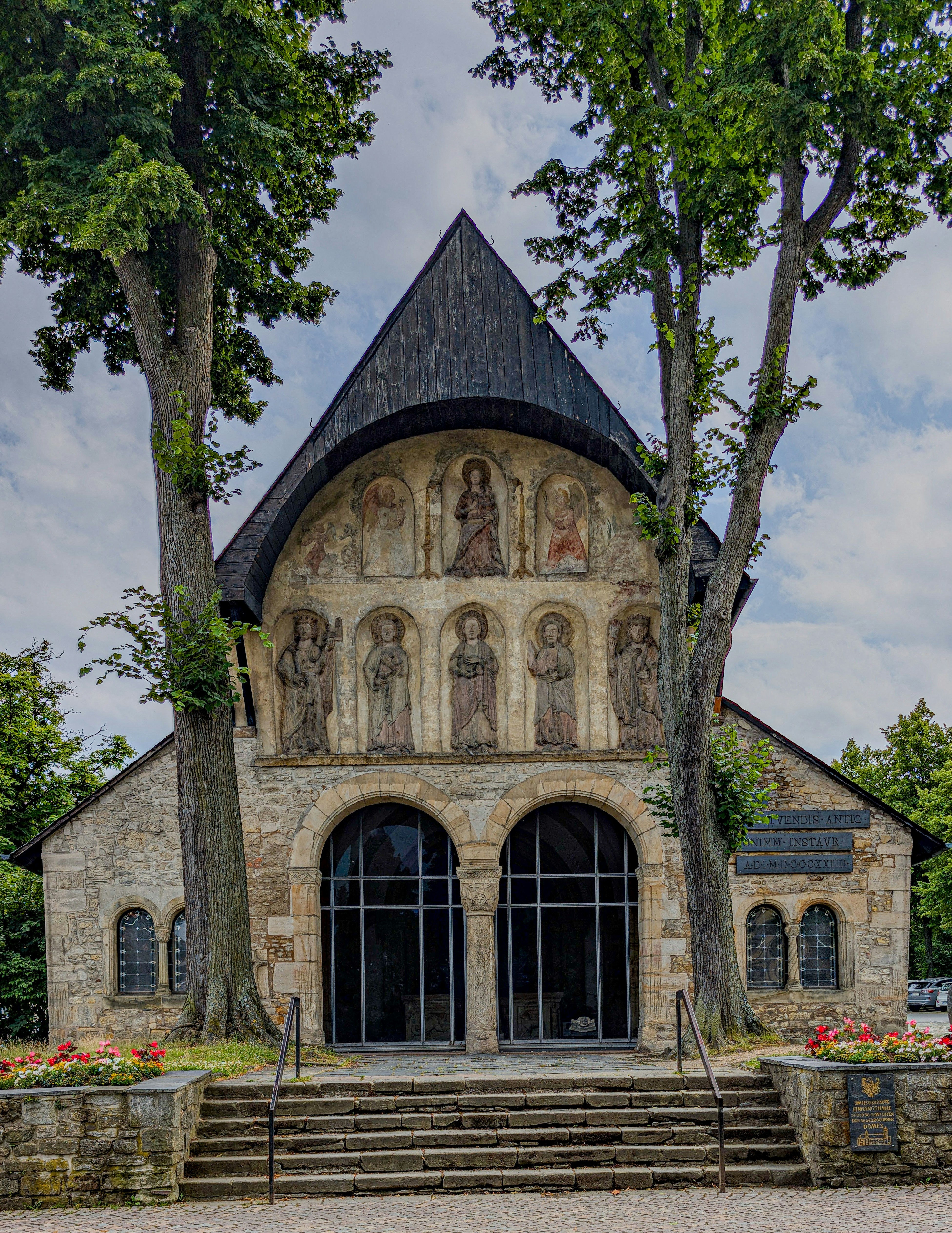 A church with a steeple surrounded by trees