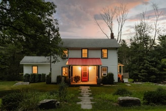 A small white house with a red awning