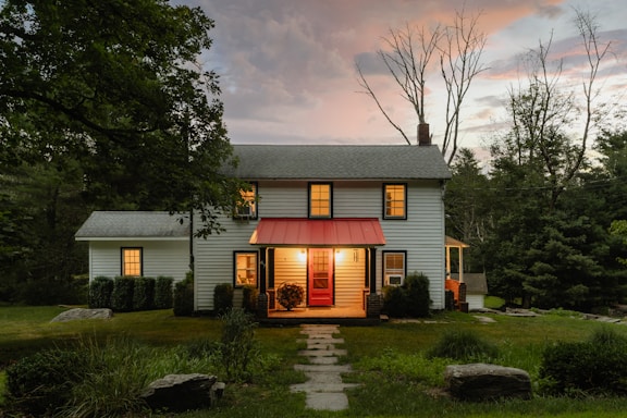 A small white house with a red awning