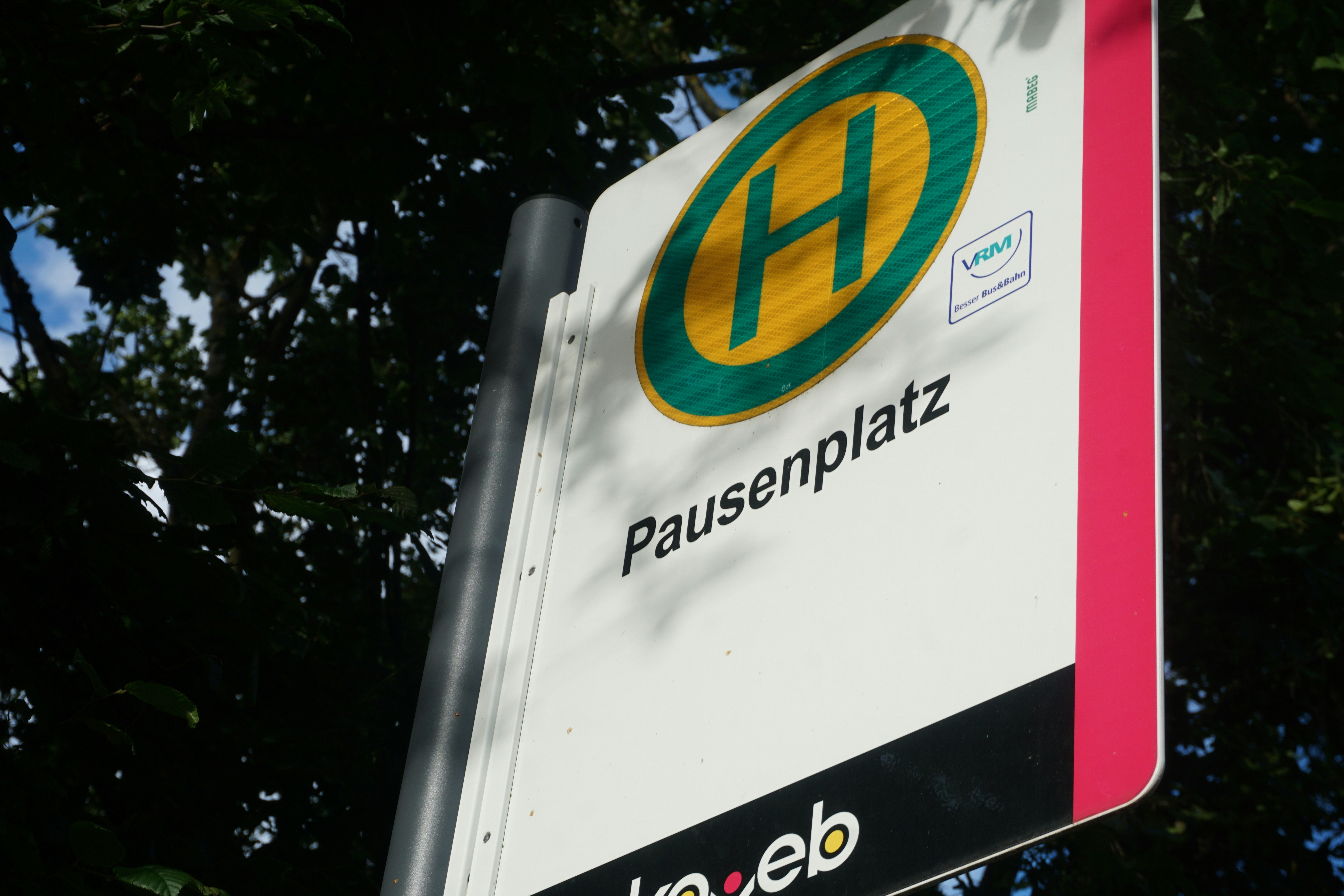 A close up of a street sign with trees in the background