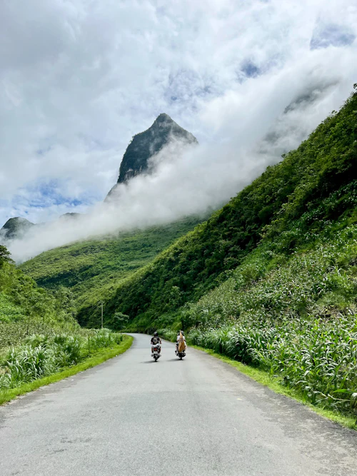 Two riders on a mountain road