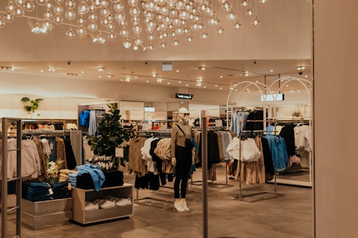 A store filled with lots of clothing and a chandelier
