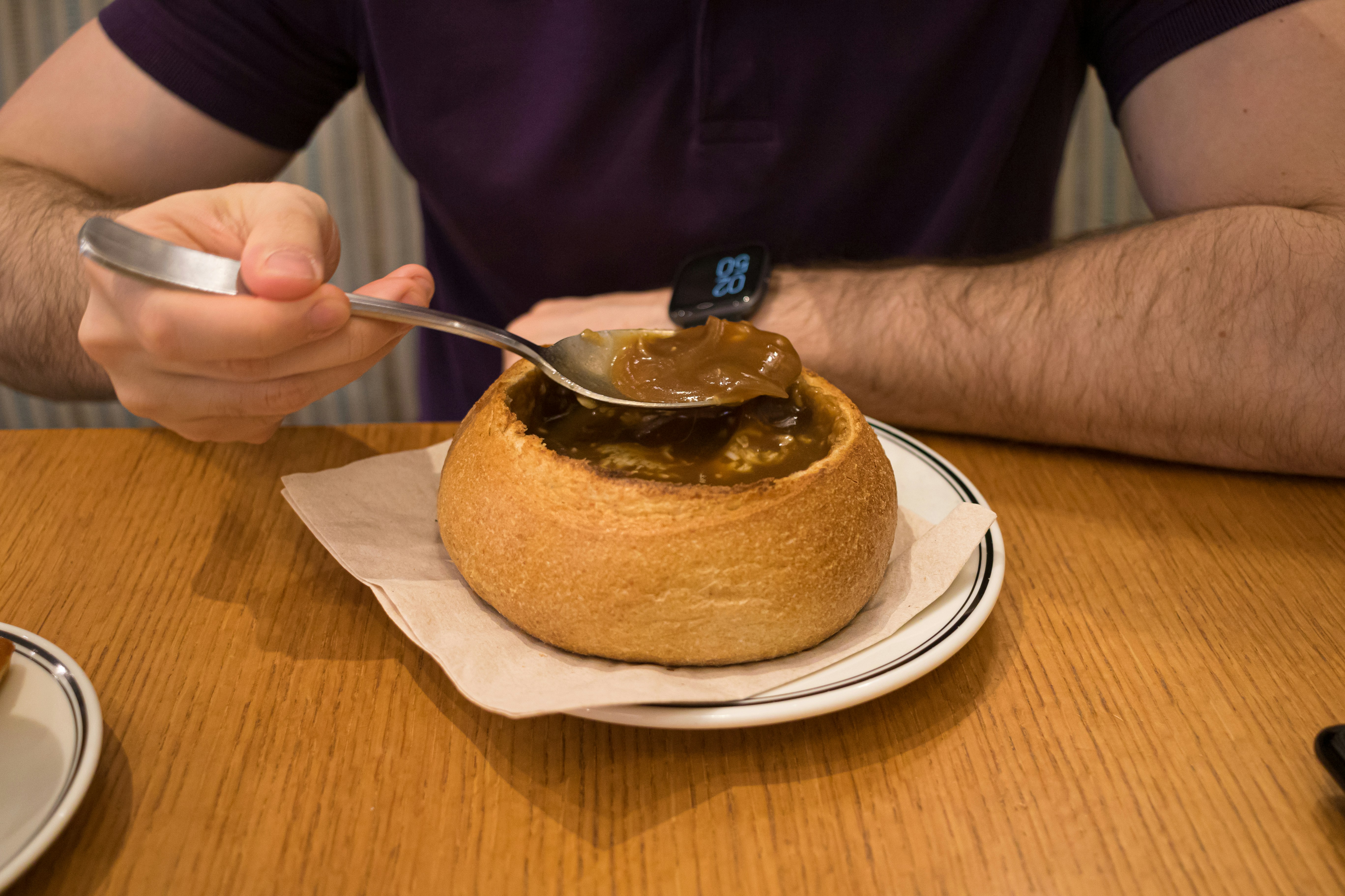 A man sitting at a table with a spoon in his hand