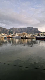 A body of water with a mountain in the background