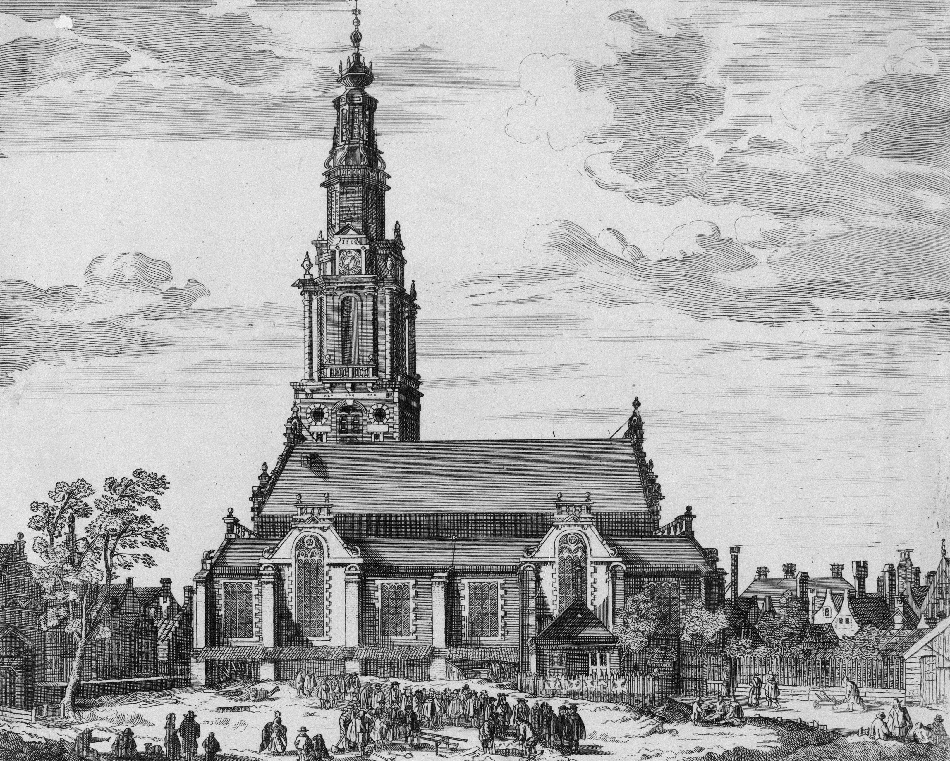 An old church with a tall steeple and surrounding buildings