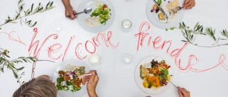A group of people sitting at a table with plates of food