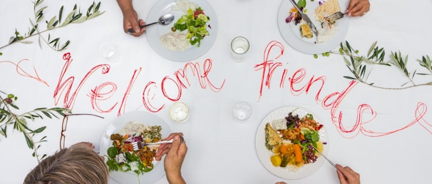A group of people sitting at a table with plates of food
