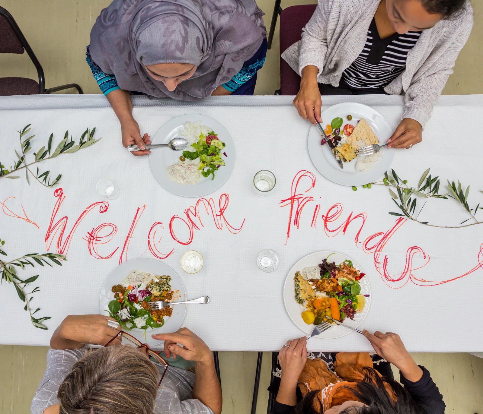 A friendly group sharing food and conversation around a table