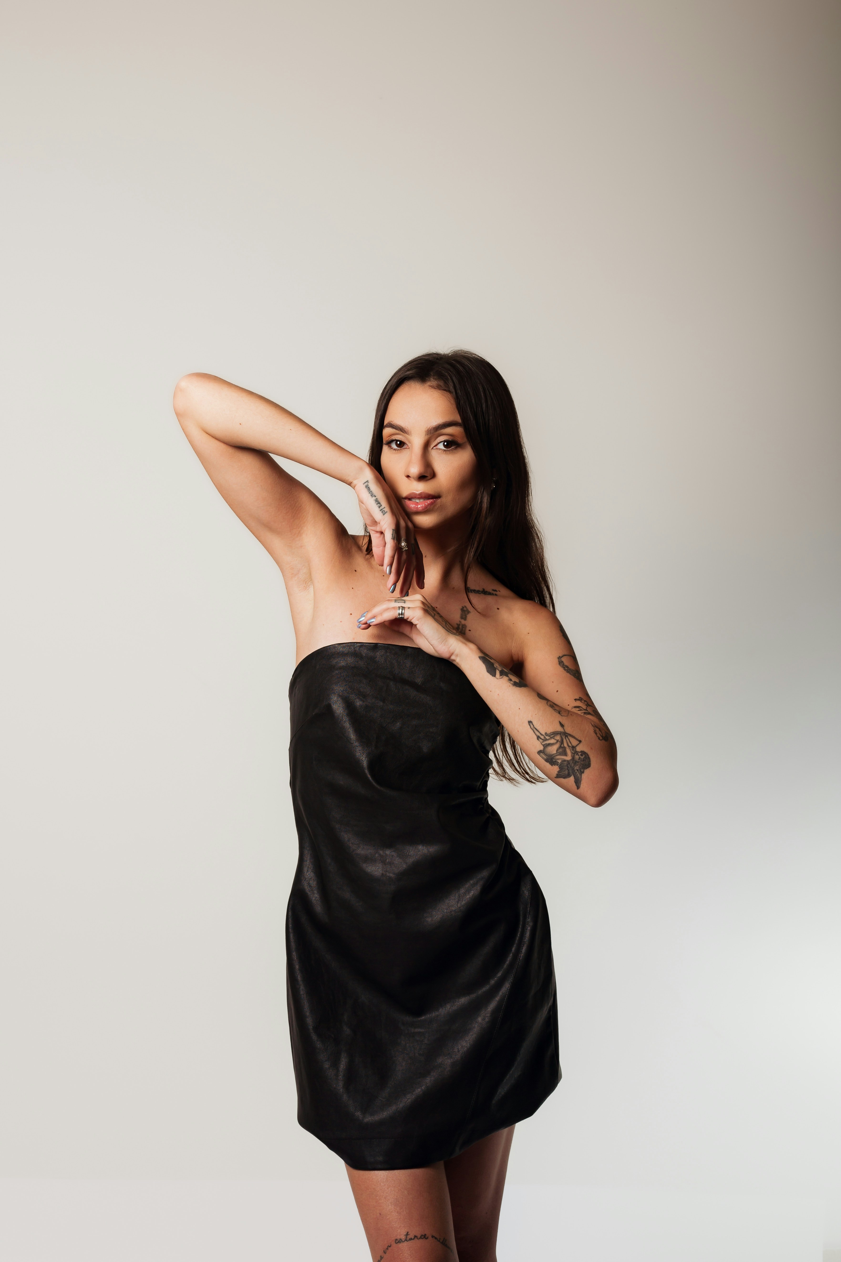 A woman in a black dress posing for a picture