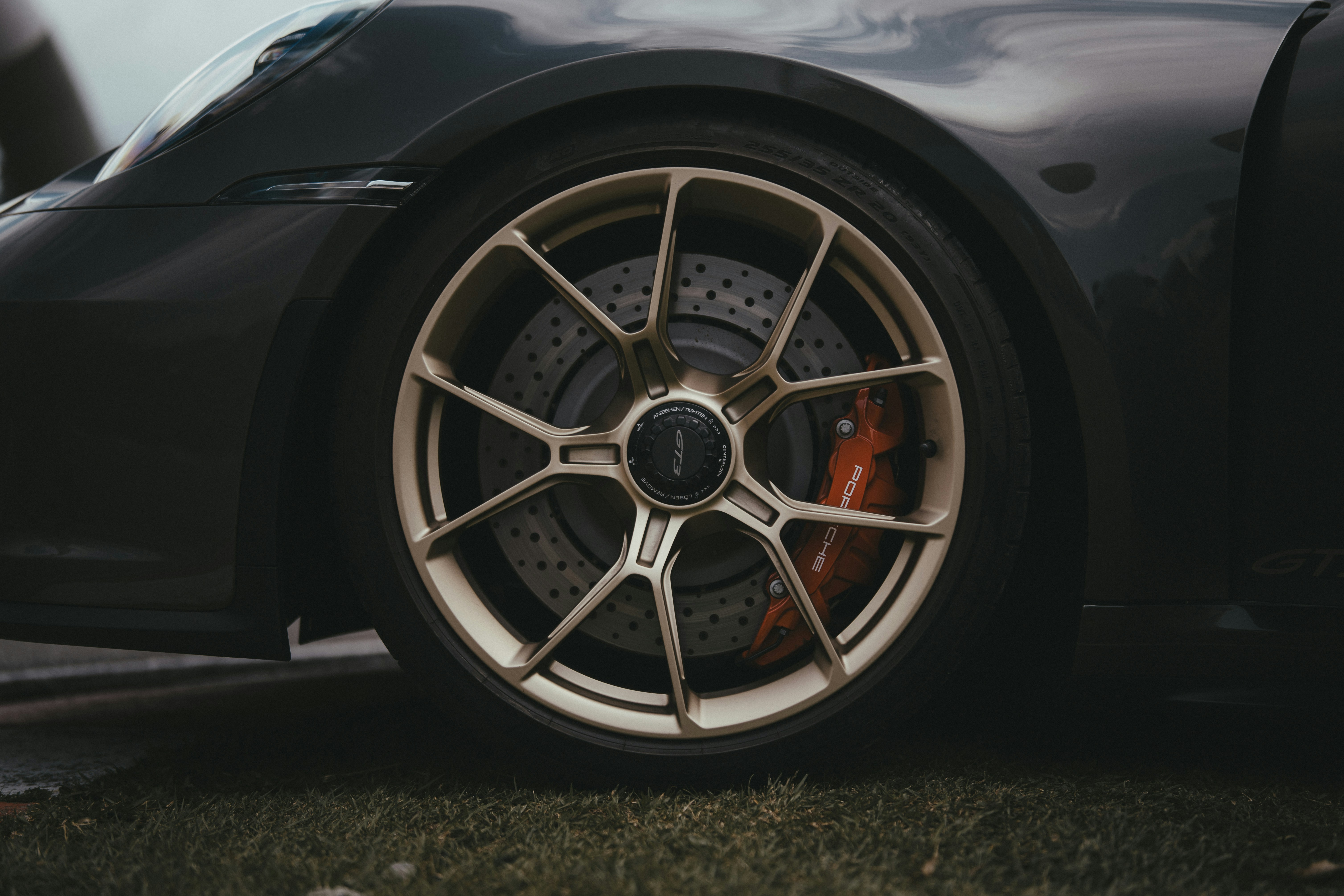 A black sports car parked on the grass