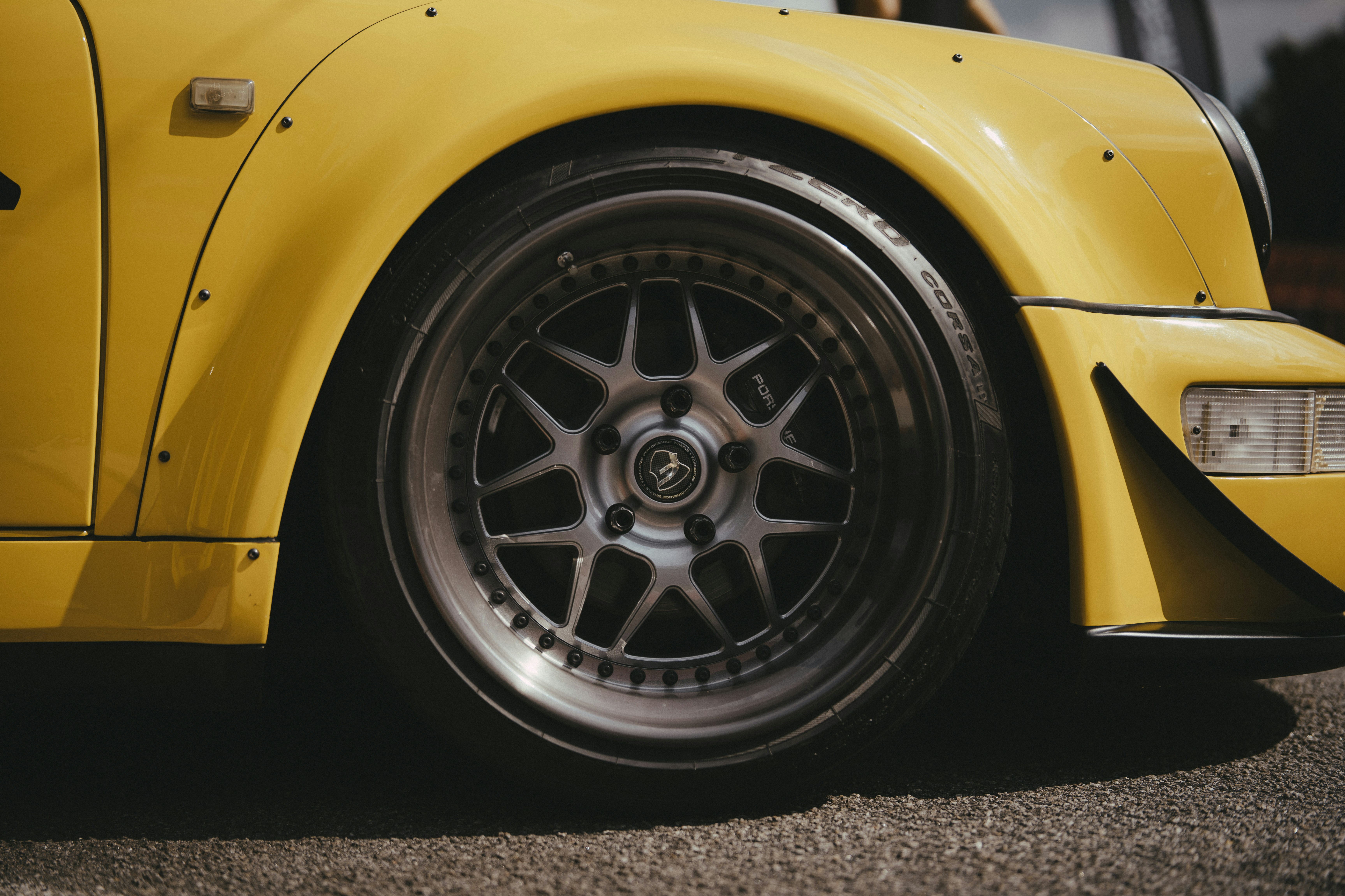 A close up of a yellow sports car