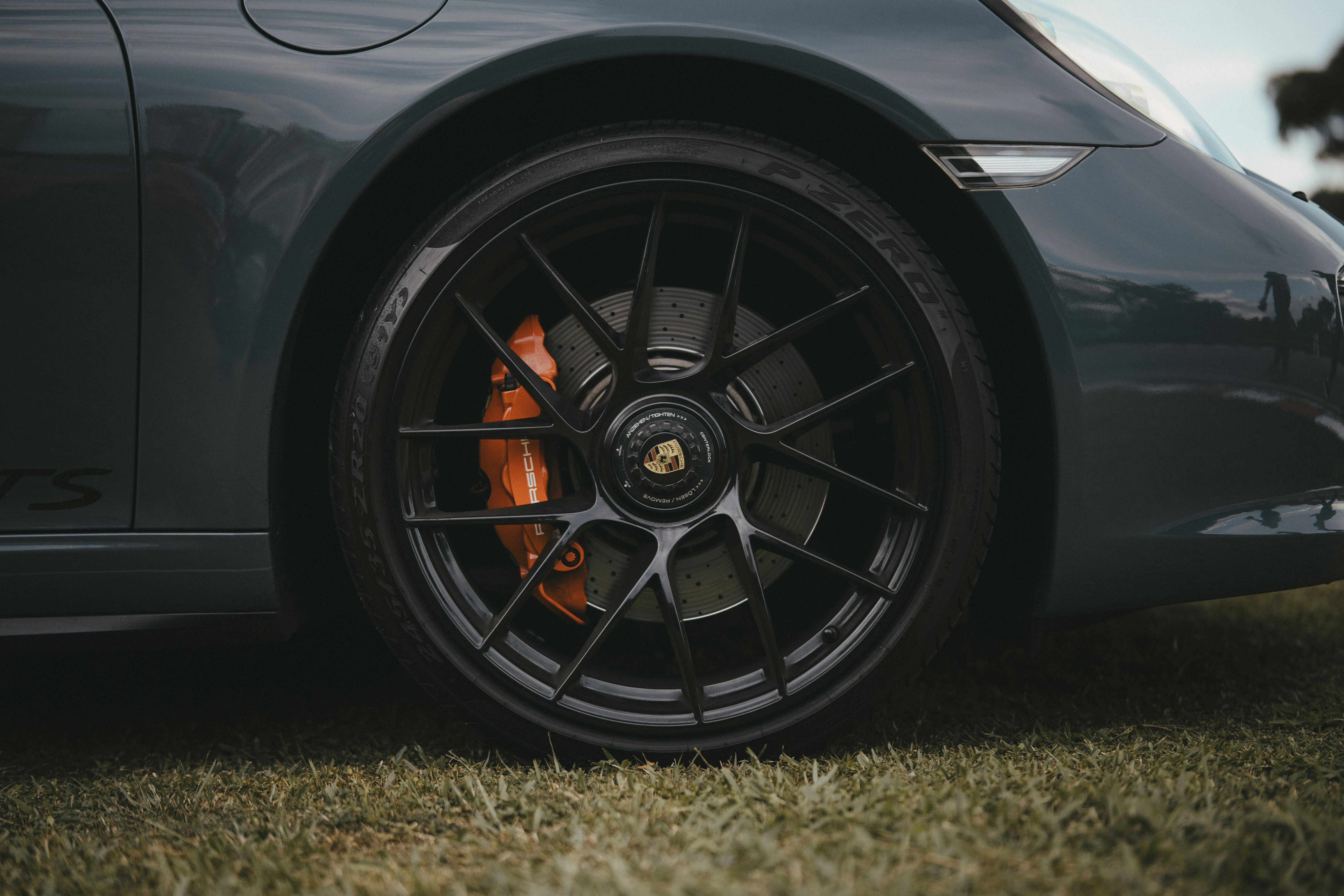 A close up of a car parked on a grass covered field