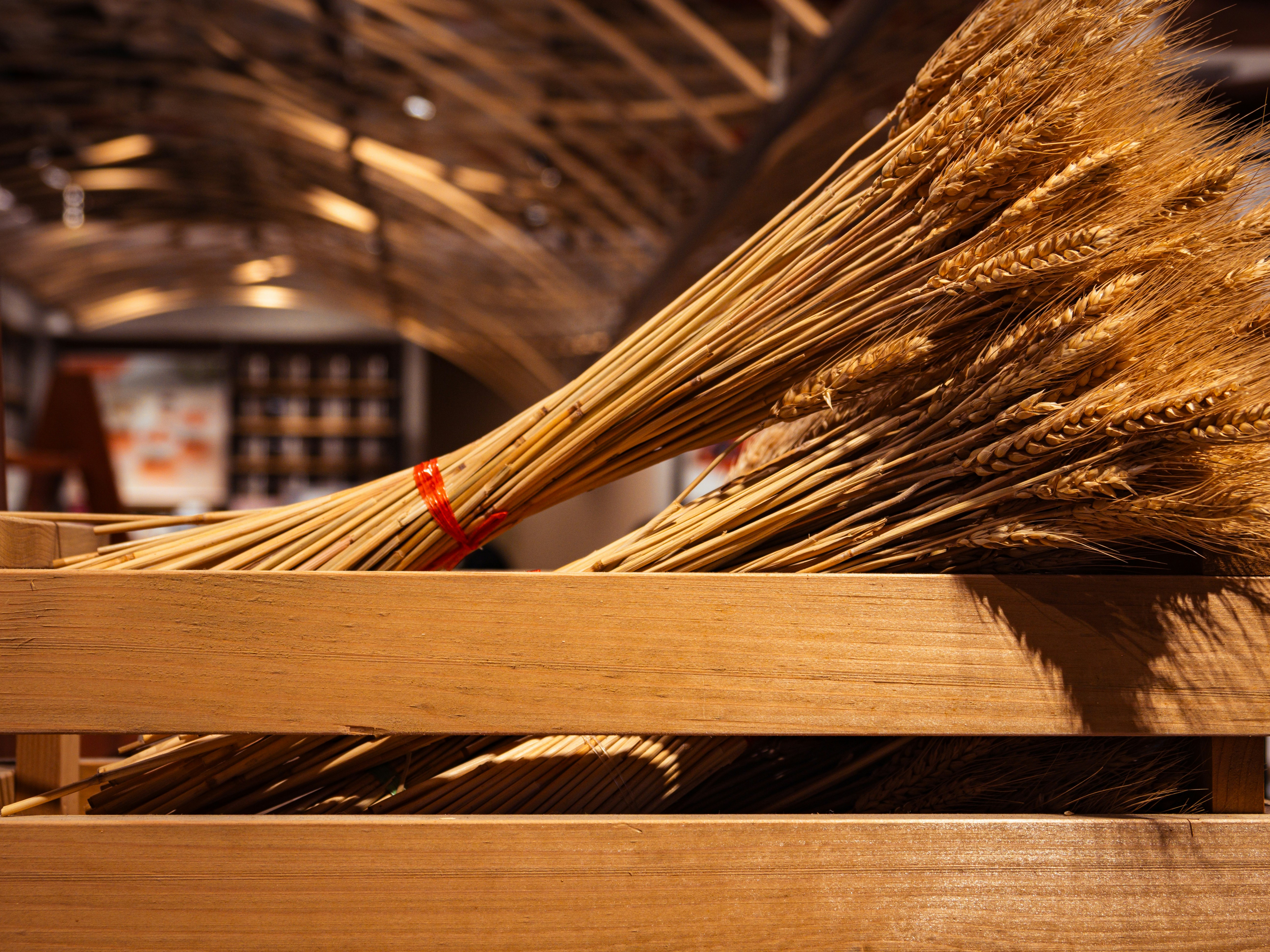 A bunch of brooms sitting on top of a wooden crate